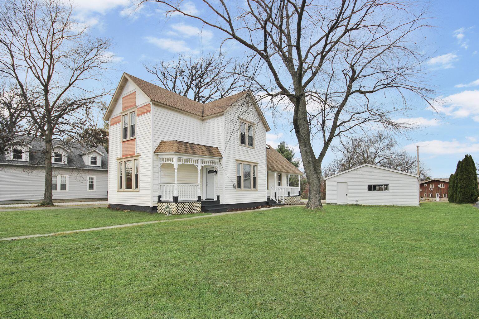 10450 West 93rd Avenue St. John, IN 46373 - Photo 14 of 22 a front view of a house with a yard and trees