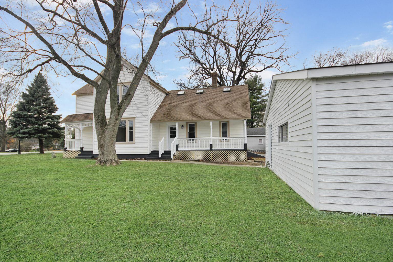 10450 West 93rd Avenue St. John, IN 46373 - Photo 15 of 22 a front view of a house with a garden and trees