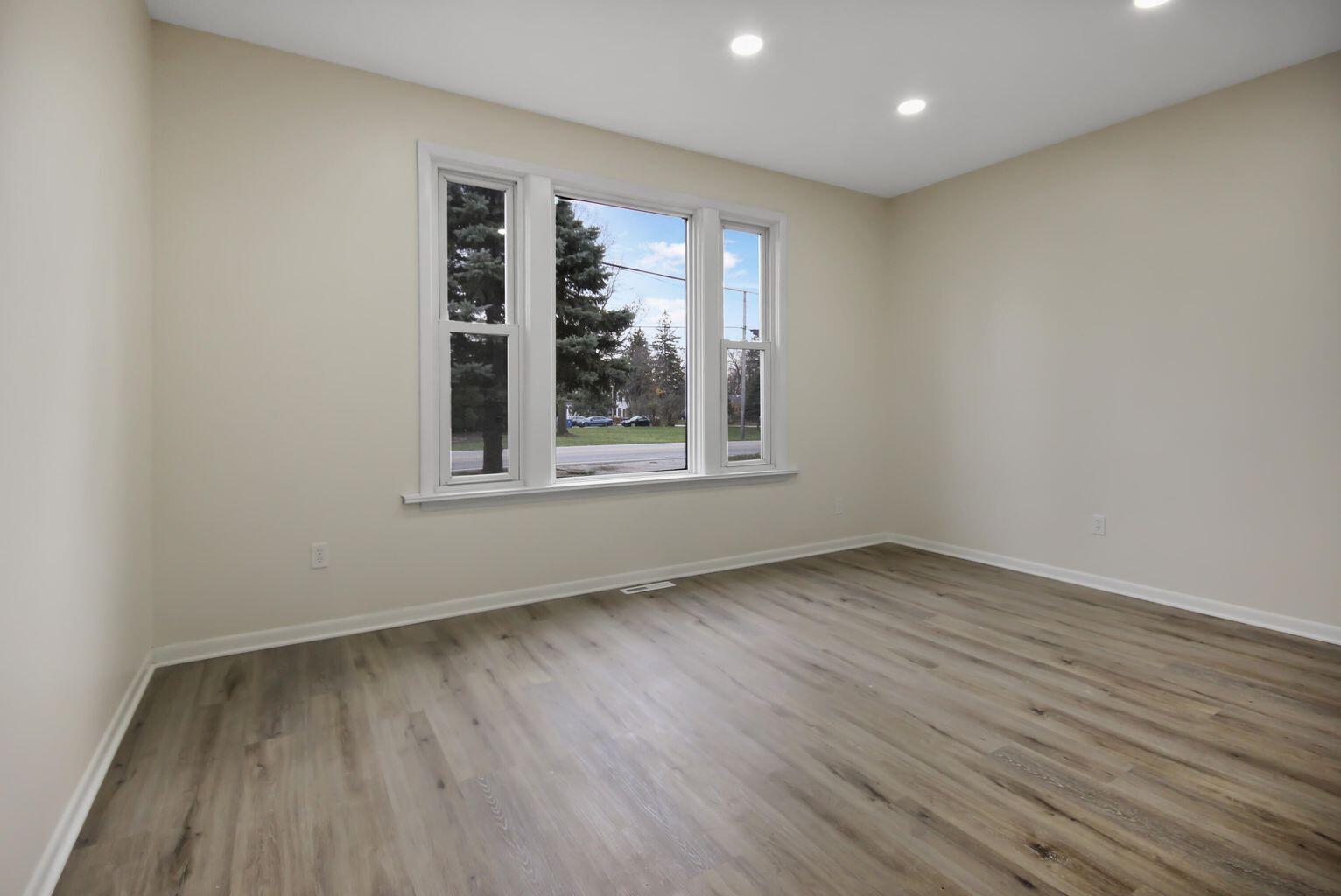 10450 West 93rd Avenue St. John, IN 46373 - Photo 16 of 22 an empty room with wooden floor and windows