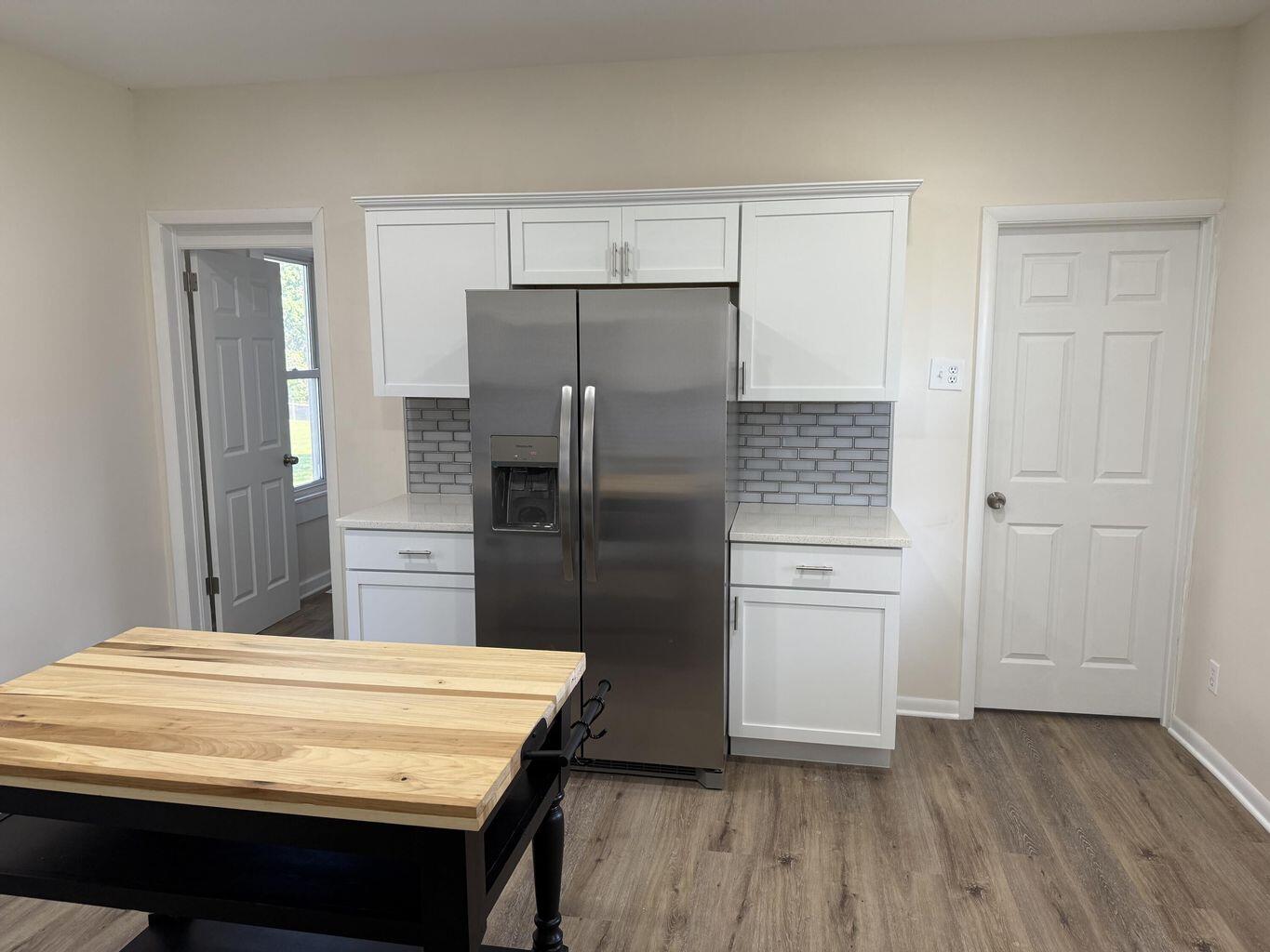 10450 West 93rd Avenue St. John, IN 46373 - Photo 18 of 22 a kitchen with kitchen island white cabinets and stainless steel appliances