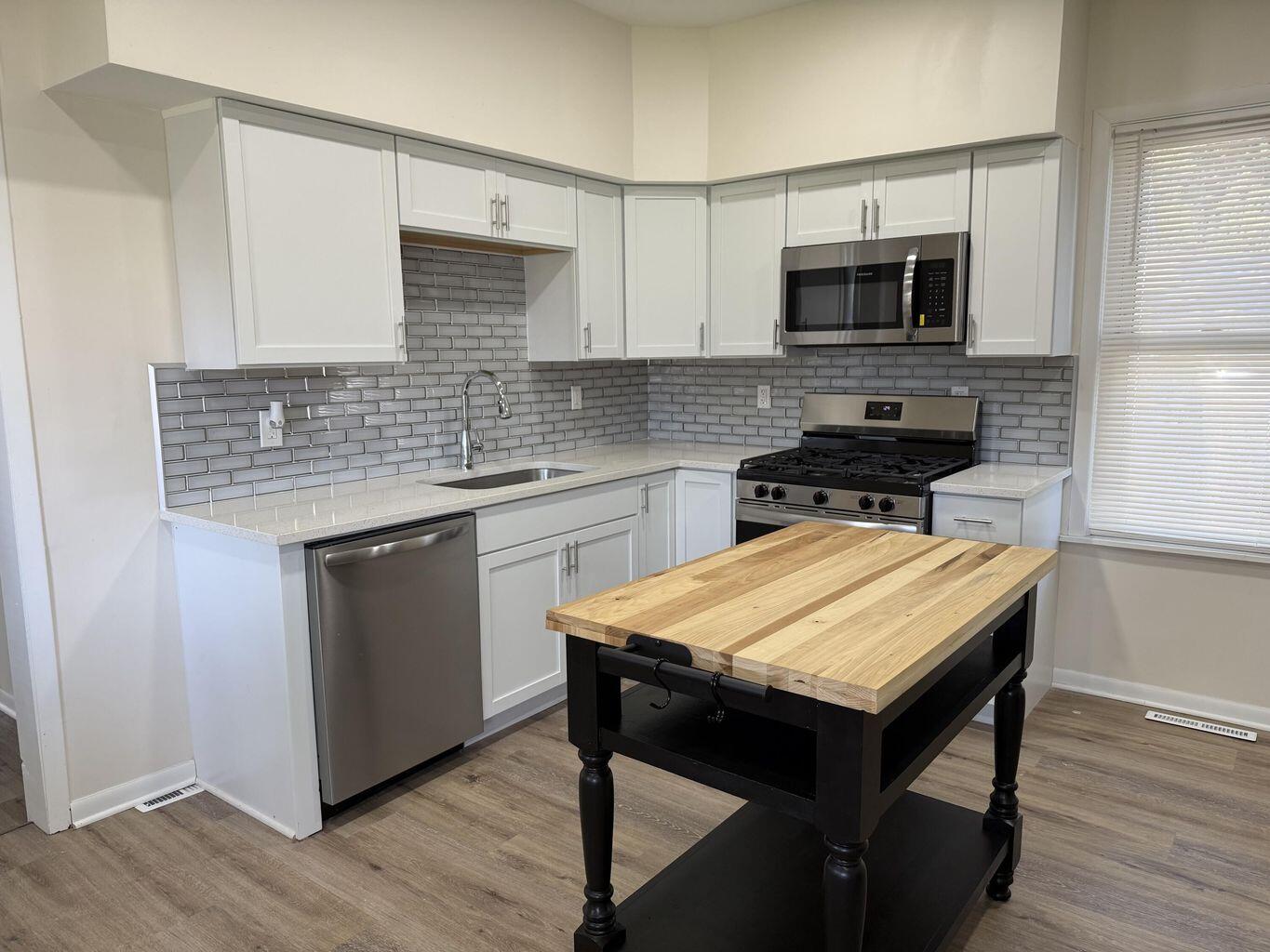 10450 West 93rd Avenue St. John, IN 46373 - Photo 20 of 22 a kitchen with a stove a sink and microwave