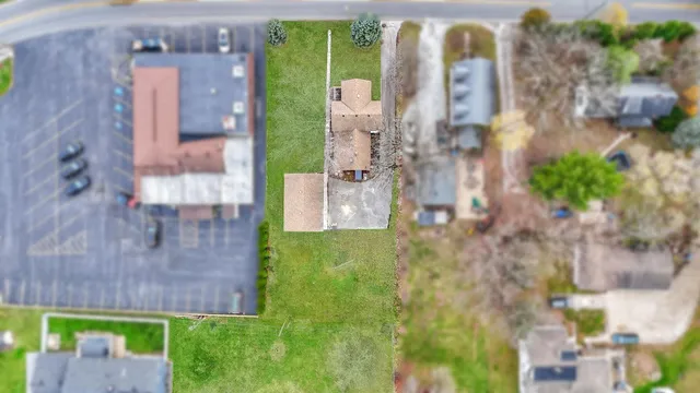 an aerial view of residential houses with outdoor space and swimming pool