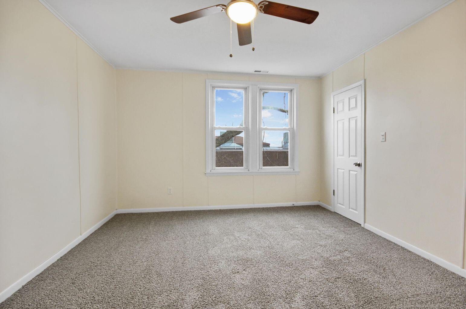 10450 West 93rd Avenue St. John, IN 46373 - Photo 6 of 22 an empty room with chandelier fan and windows