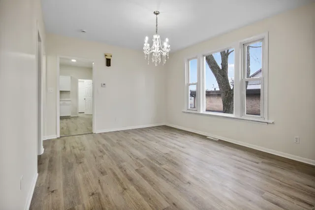 a view of livingroom with chandelier and wooden floor