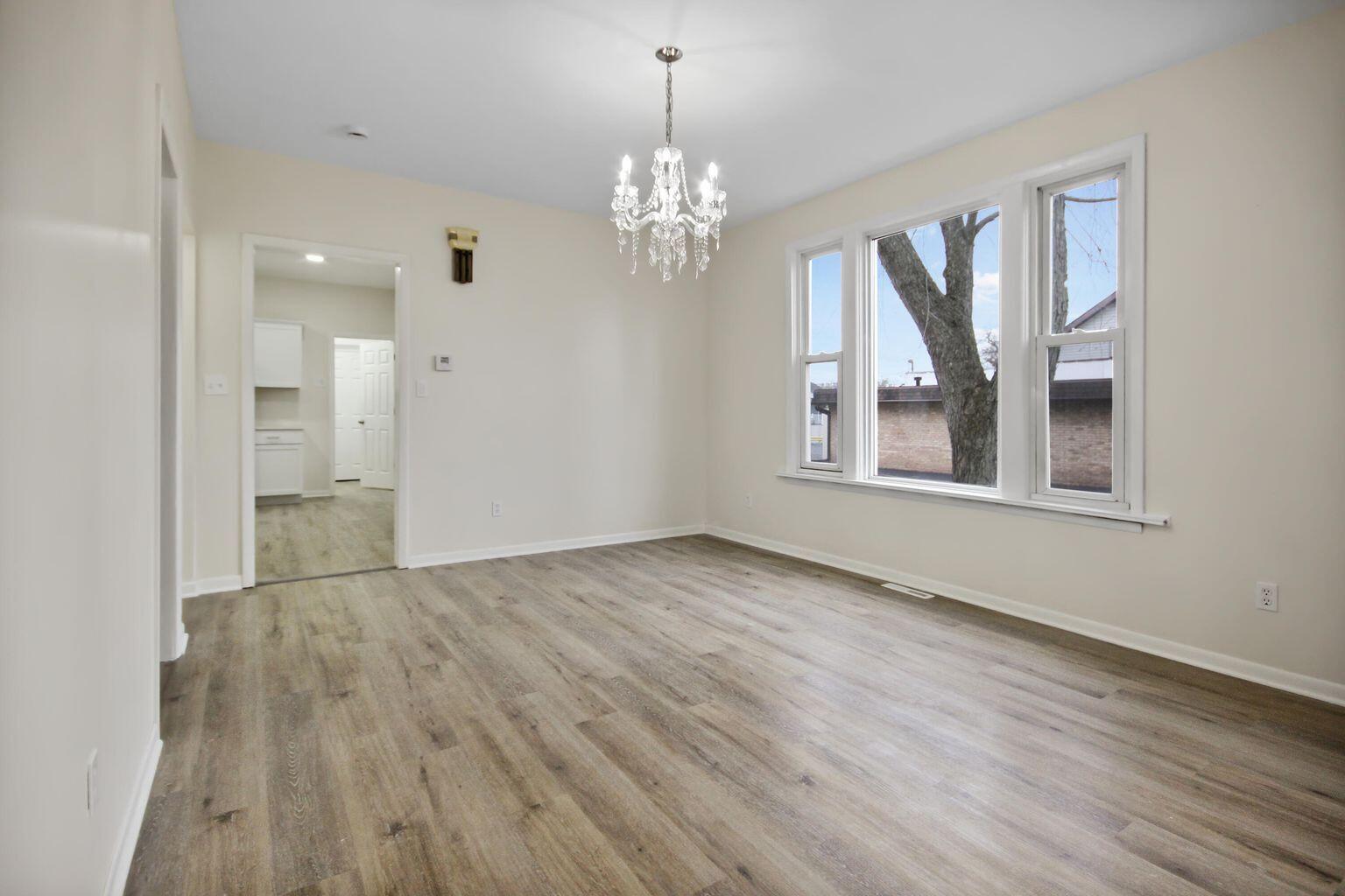 10450 West 93rd Avenue St. John, IN 46373 - Photo 9 of 22 a view of livingroom with chandelier and wooden floor