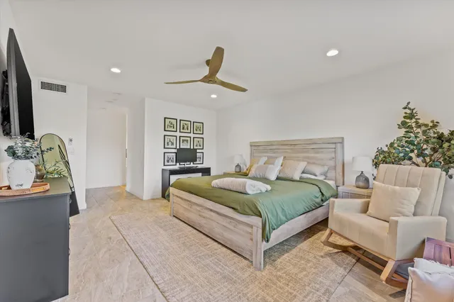 a spacious bathroom with a granite countertop sink a toilet and a mirror