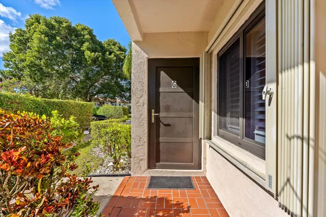 a view of entryway with a floor to ceiling window and wooden floor