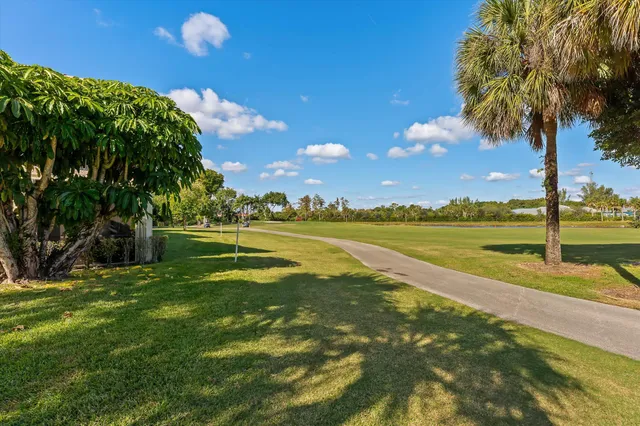 a view of a house with a swimming pool and a yard