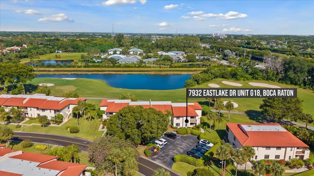 an aerial view of residential houses with outdoor space and a lake view