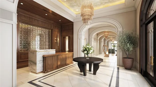 a lobby with furniture and a chandelier