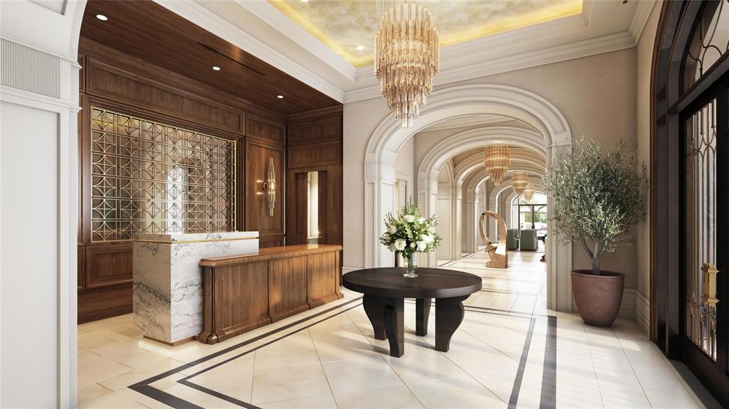 a lobby with furniture and a chandelier