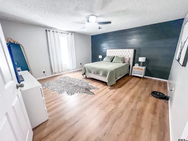 a spacious bedroom with a bed and a window