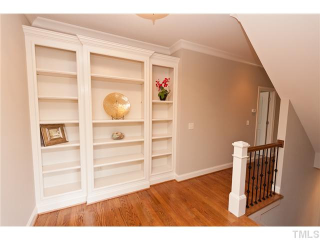 8512 Wynhurst Court Raleigh, NC 27613 - Photo 18 of 25 Top the stairs to find this wonderful built in book case along with durable hardwood floors. Other