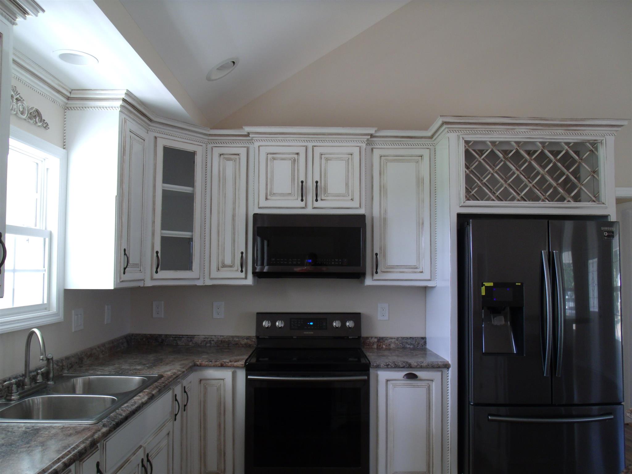 26 Liberty Road Winchester, TN 37398 - Photo 4 of 16 Kitchen with custom cabinets and plenty of storage and counter space. Wine rack over fridge and easy close cabinet doors.