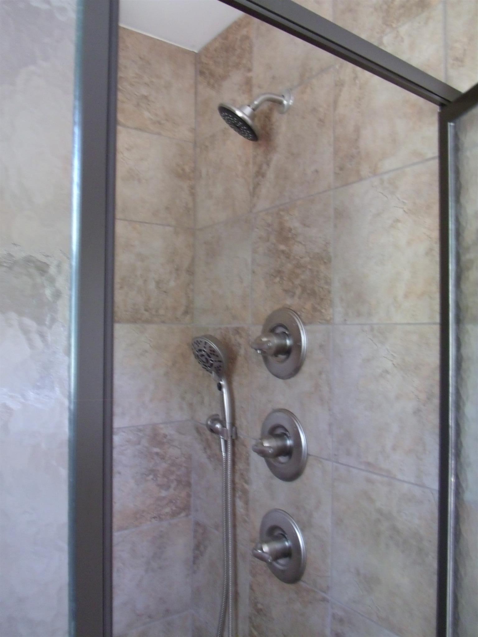 26 Liberty Road Winchester, TN 37398 - Photo 9 of 16 Fabulous tile shower in master with rain shower head, a bench seat, and two other shower heads.