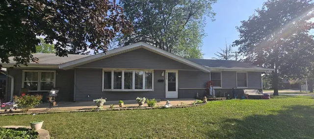 a front view of house with yard slide and outdoor seating