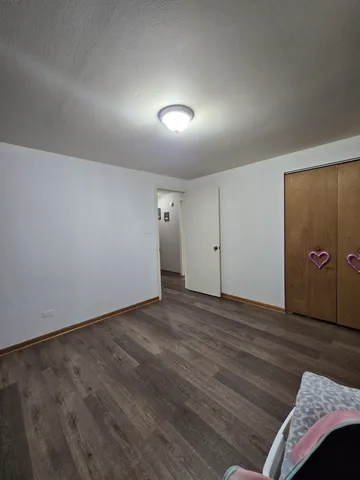 a living room with furniture a fireplace and wooden floor