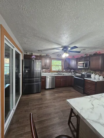 a room with a table chairs and a chandelier