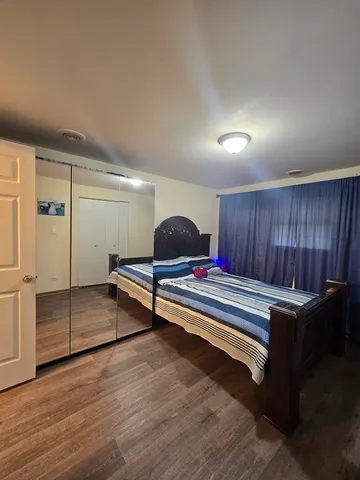 a bedroom with a bed and a dresser