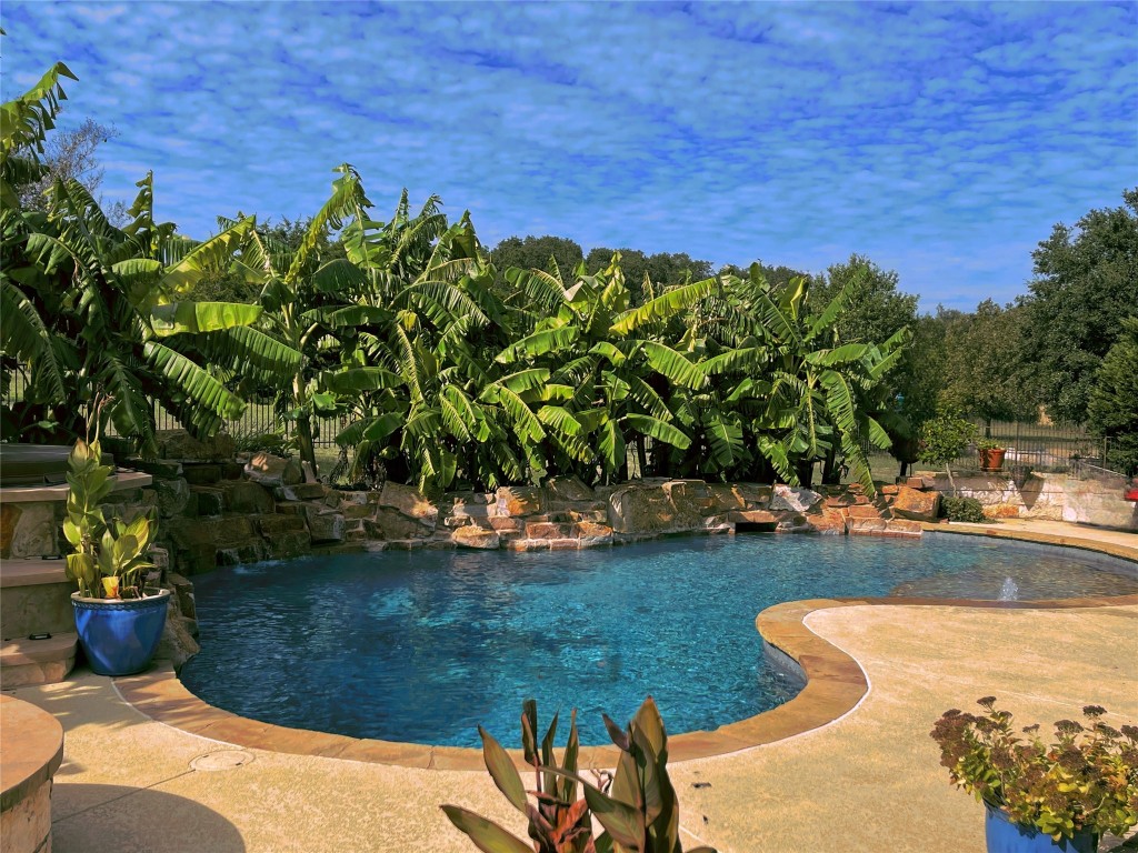 a view of a backyard with swimming pool