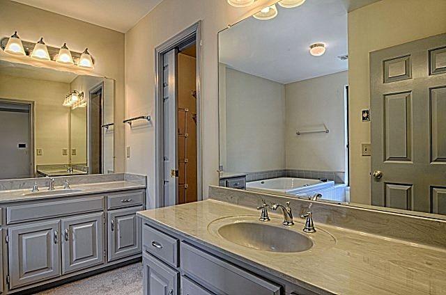 602 Gen George Patton Road Nashville, TN 37221 - Photo 13 of 20 The master bathroom features true double vanities, where the two sinks and cabinets are separate. The light fixtures, paint, sink hardware, cabinetry hardware, and showerhead are all new.