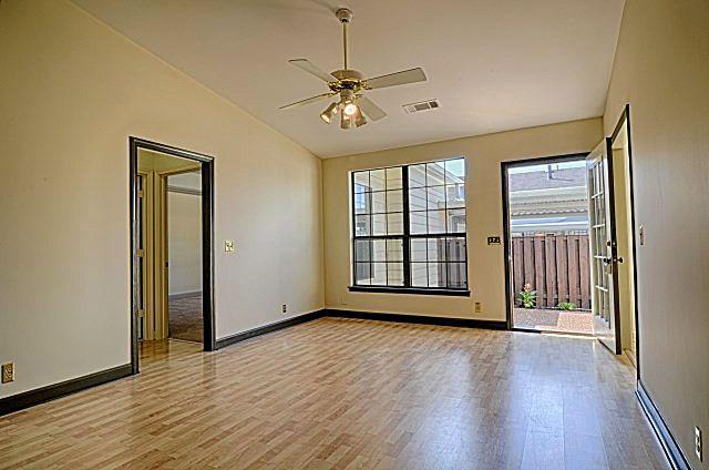 602 Gen George Patton Road Nashville, TN 37221 - Photo 6 of 20 The den, open to the kitchen, enjoys a ceiling fan light fixture, a lovely wood-burning fireplace, new flooring, new lower panels on the large window, and access to the enclosed back patio.