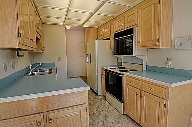 602 Gen George Patton Road Nashville, TN 37221 - Photo 10 of 20 The kitchen has lots of space in the light oak cabinets and a double-bowl stainless steel sink. The refrigerator will remain with the home.