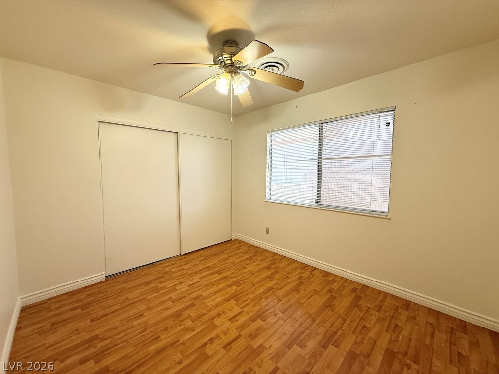 616 Greenway Road Henderson, NV 89002 - Photo 19 of 32 Wood flooring and ceiling fan provide comfort in this naturally illuminated bedroom.