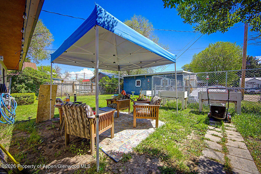 625 Russell Street Craig, CO 81625 - Photo 15 of 35 a view of a patio with table and chairs under an umbrella