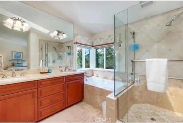 a spacious bathroom with a granite countertop sink mirror and shower