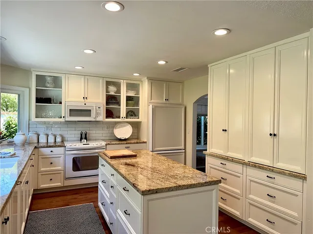 a kitchen with a stove and a refrigerator