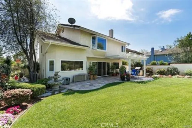 a view of a house with backyard porch and sitting area