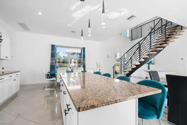 a kitchen with stainless steel appliances granite countertop a stove a refrigerator and a sink