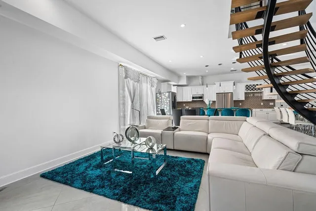 a bedroom with furniture and a large window