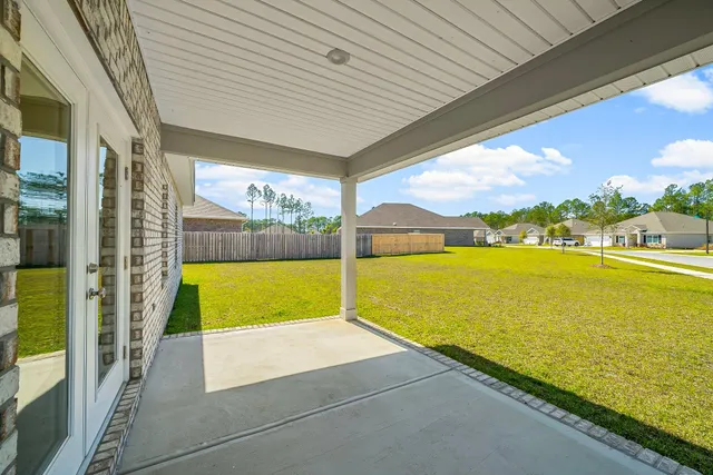 a view of a house with pool and yard