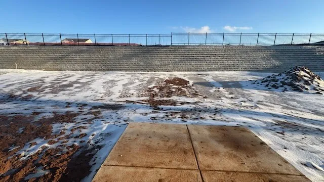 a kitchen with stainless steel appliances granite countertop a stove a sink a refrigerator with white cabinets and wooden floor