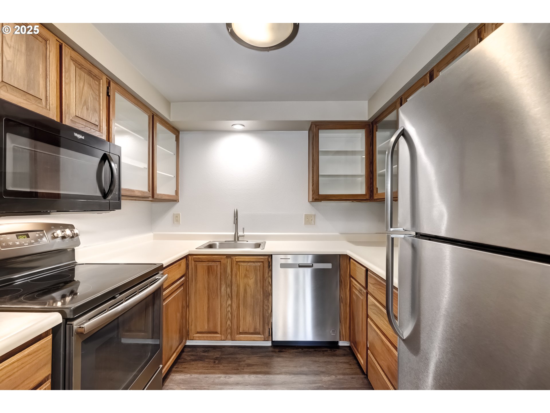 5557 Southwest Multnomah Boulevard Portland, OR 97219 - Photo 12 of 29 a kitchen with stainless steel appliances granite countertop a sink stove and refrigerator
