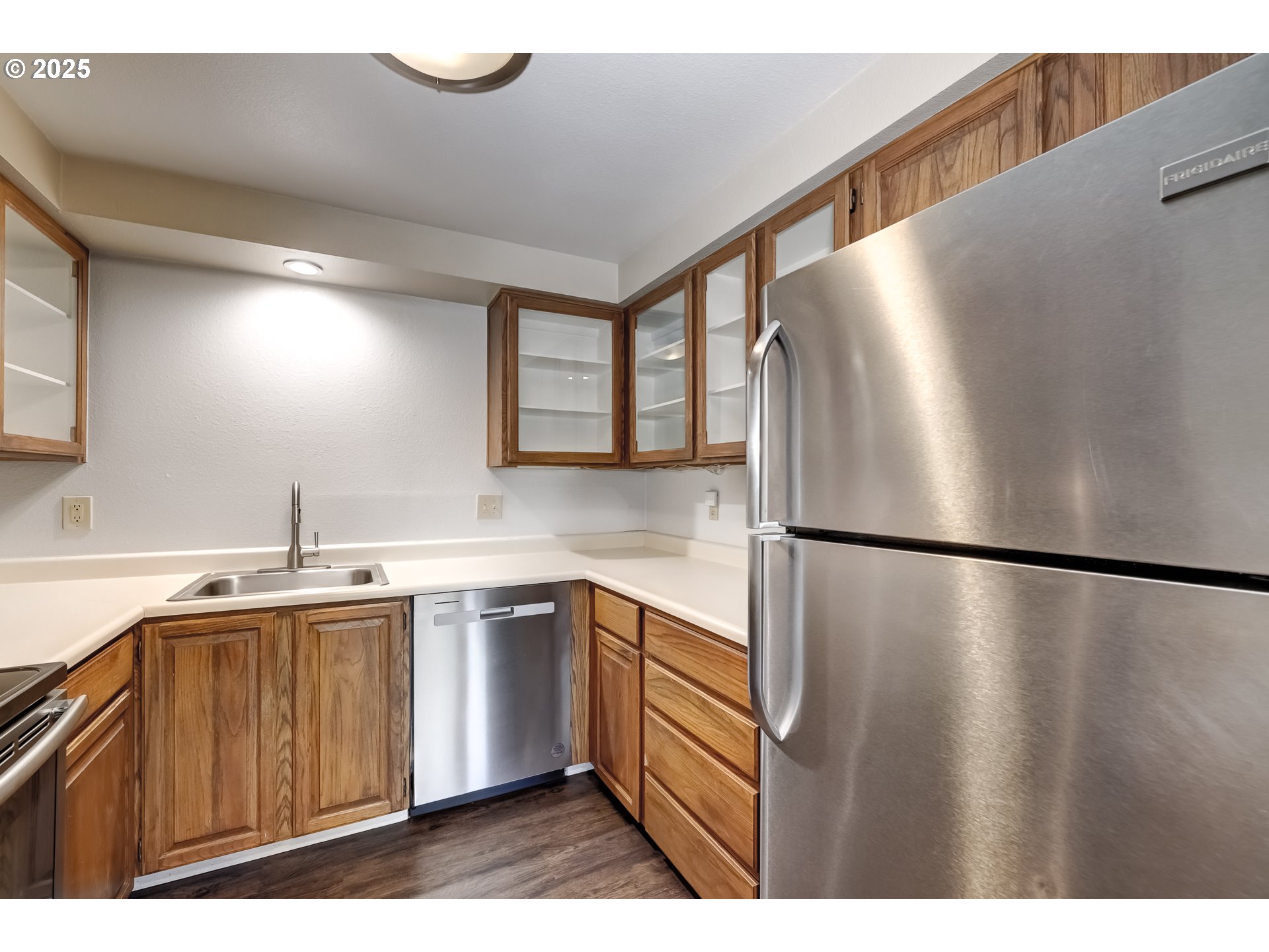 5557 Southwest Multnomah Boulevard Portland, OR 97219 - Photo 13 of 29 a kitchen with a refrigerator sink and cabinets