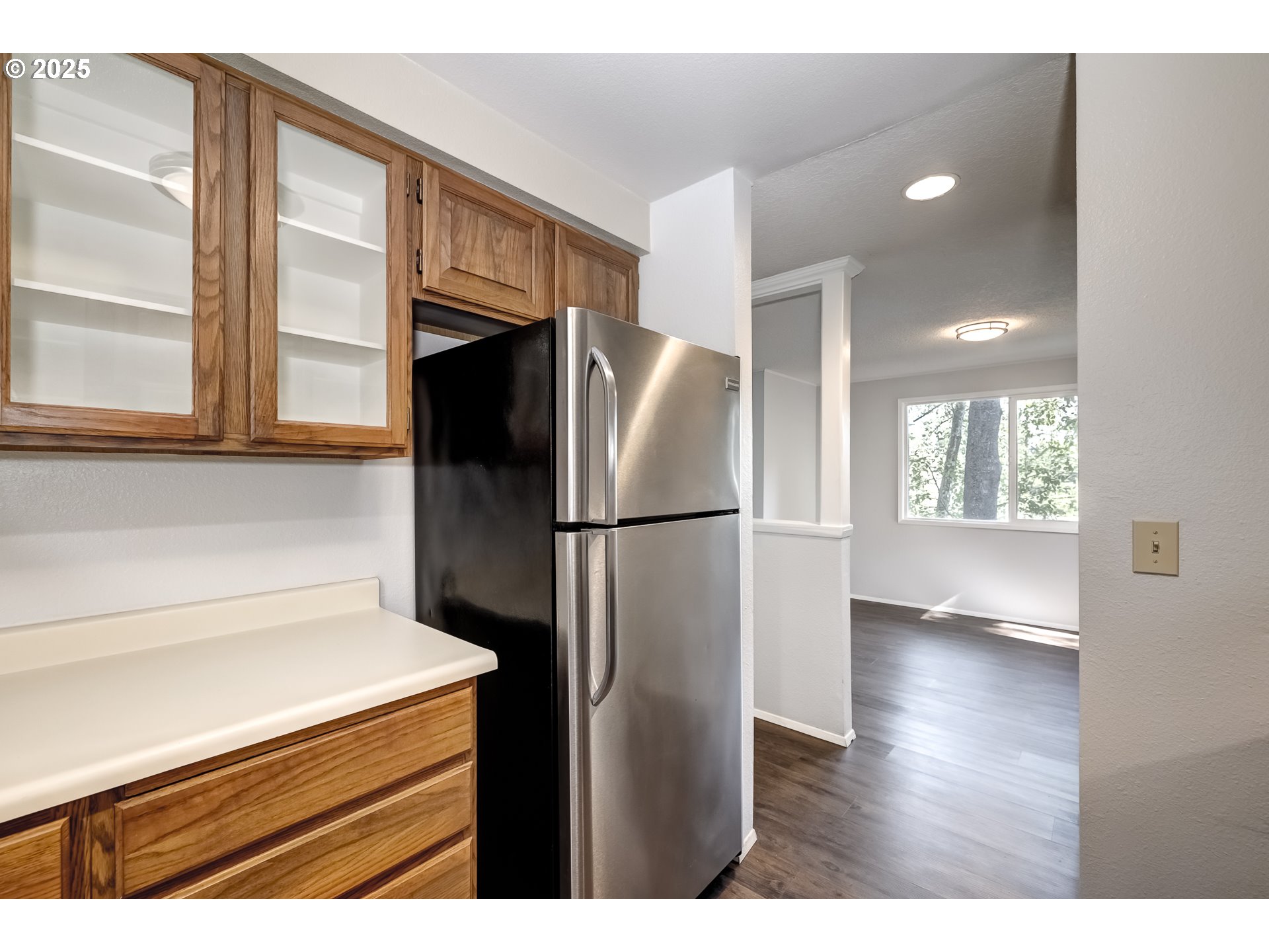 5557 Southwest Multnomah Boulevard Portland, OR 97219 - Photo 15 of 29 a kitchen view with a refrigerator and wooden floor
