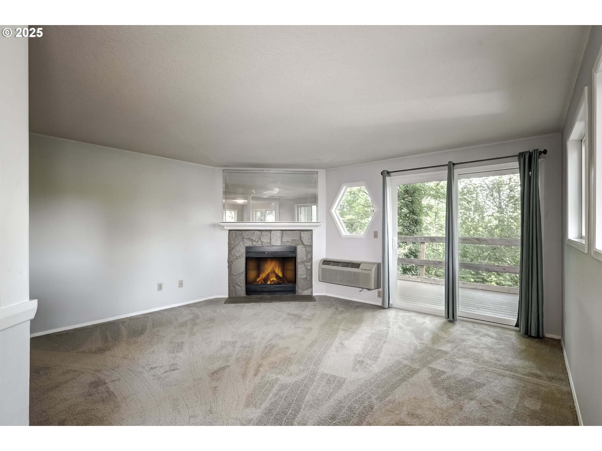 5557 Southwest Multnomah Boulevard Portland, OR 97219 - Photo 5 of 29 a view of an empty room with a fireplace