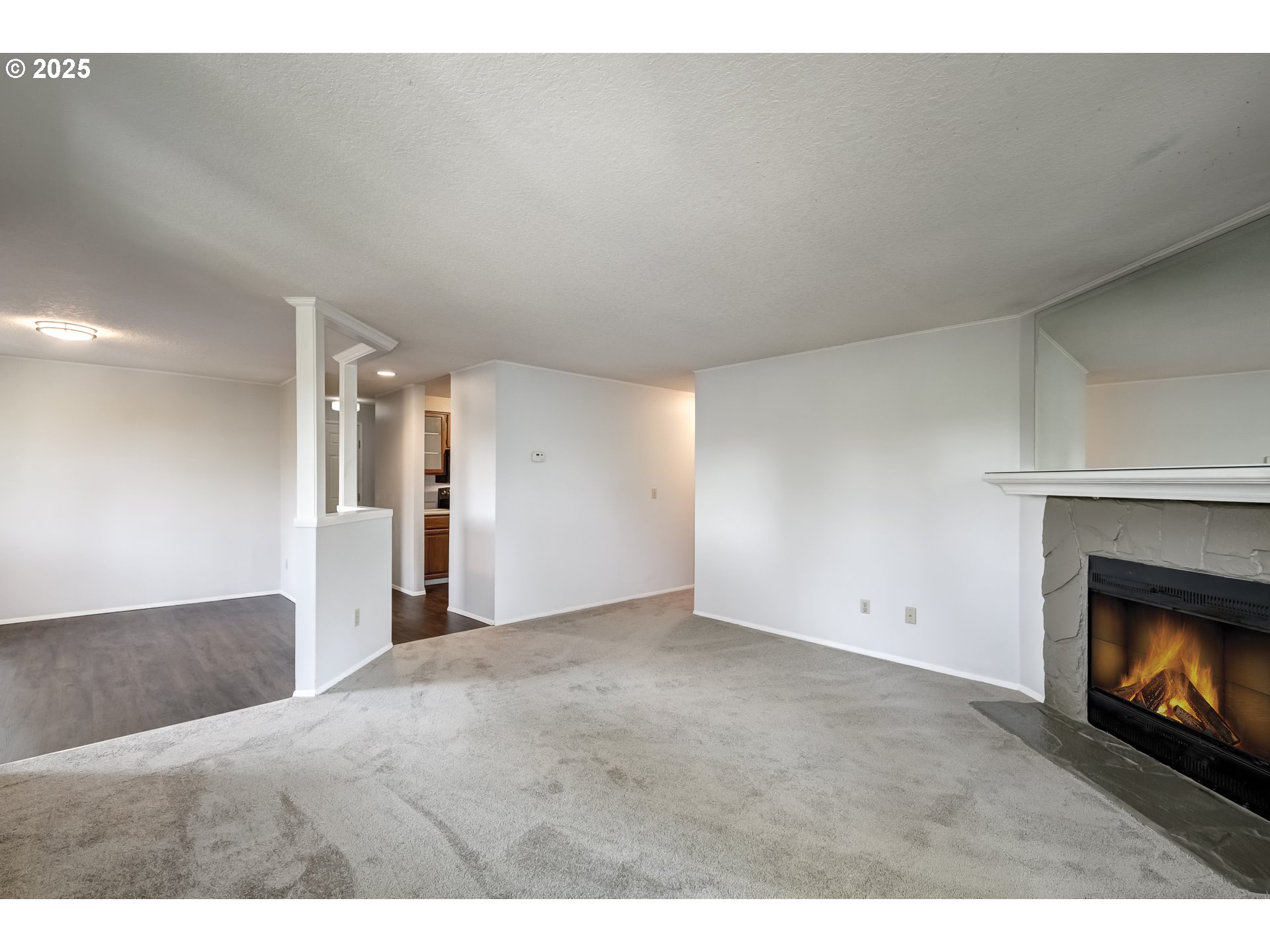 5557 Southwest Multnomah Boulevard Portland, OR 97219 - Photo 7 of 29 a view of an empty room and fire place