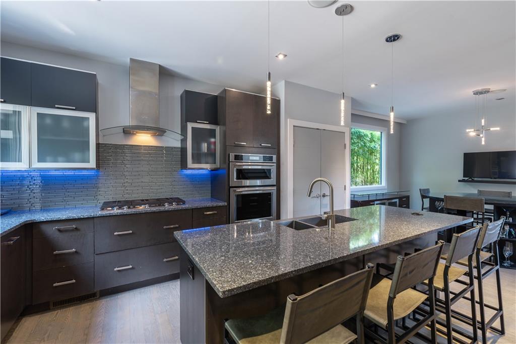 892 Durant Place Northeast Atlanta, GA 30309 - Photo 12 of 51 a kitchen with granite countertop a stove a sink and a refrigerator
