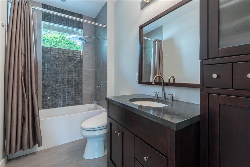 892 Durant Place Northeast Atlanta, GA 30309 - Photo 16 of 51 a bathroom with a granite countertop sink toilet and shower