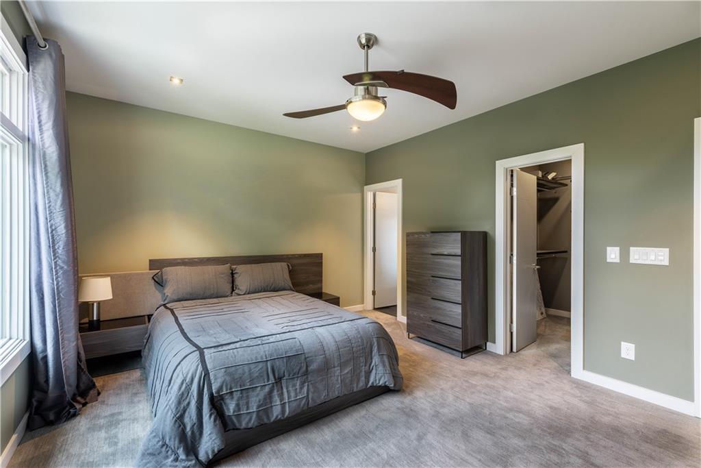 892 Durant Place Northeast Atlanta, GA 30309 - Photo 22 of 51 a bedroom with a bed and a chandelier