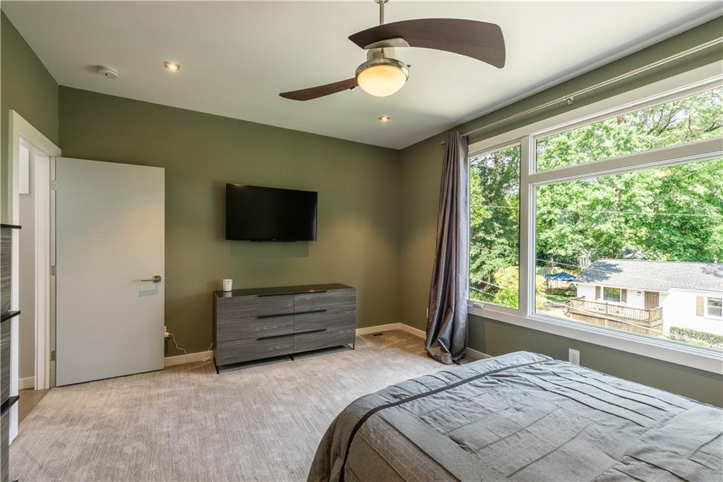 892 Durant Place Northeast Atlanta, GA 30309 - Photo 23 of 51 a bedroom with a bed and a flat screen tv