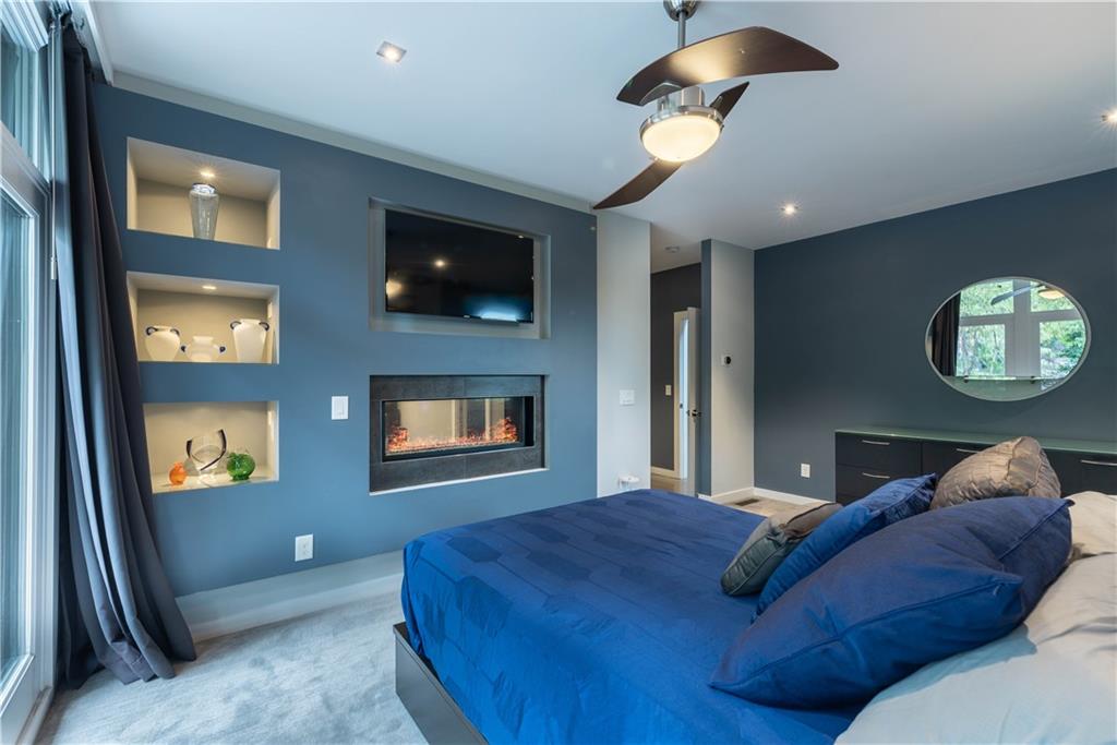 892 Durant Place Northeast Atlanta, GA 30309 - Photo 26 of 51 a bedroom with a bed and a chandelier