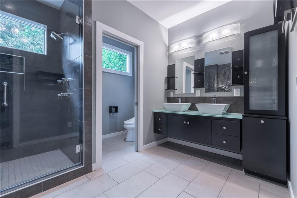 892 Durant Place Northeast Atlanta, GA 30309 - Photo 29 of 51 a spacious bathroom with a double vanity sink toilet and shower