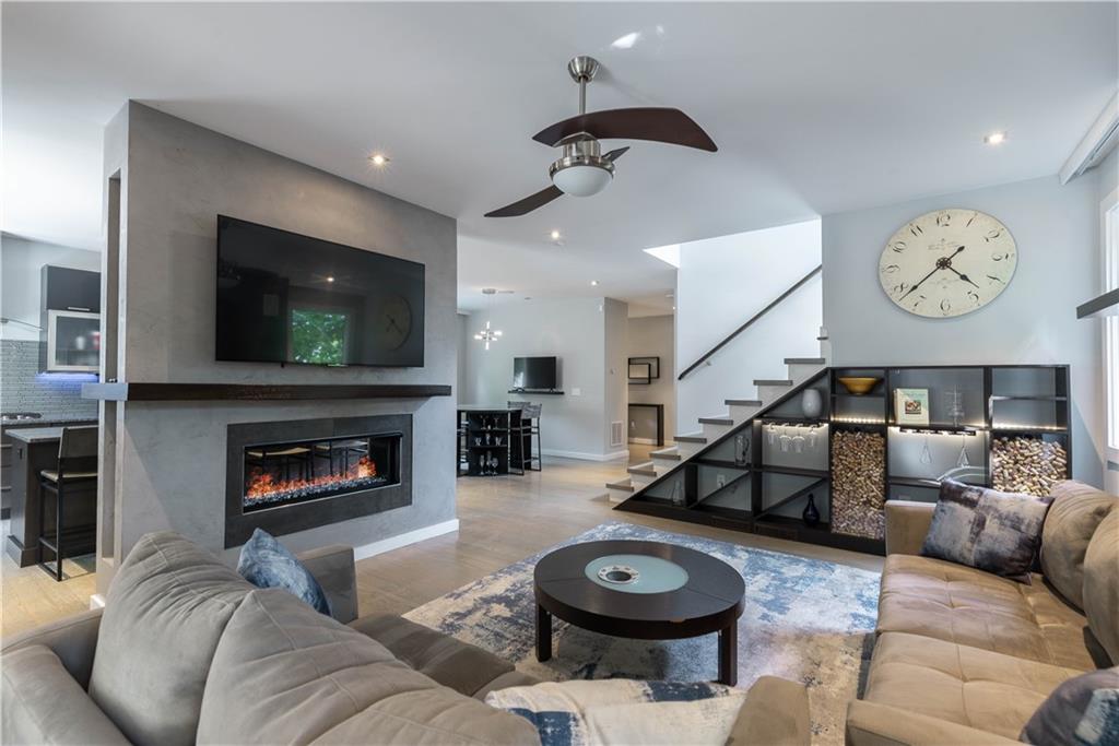 892 Durant Place Northeast Atlanta, GA 30309 - Photo 7 of 51 a living room with furniture a flat screen tv and a fireplace