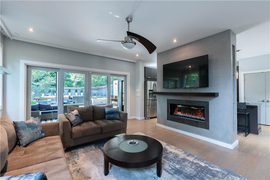 892 Durant Place Northeast Atlanta, GA 30309 - Photo 9 of 51 a living room with furniture a fireplace and a flat screen tv