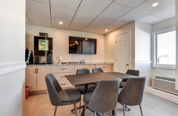 a view of a dining room with furniture and window